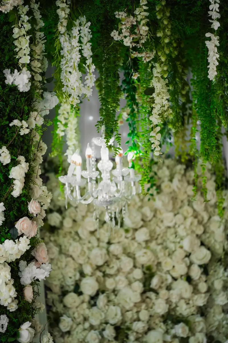 Cascading greenery and white roses